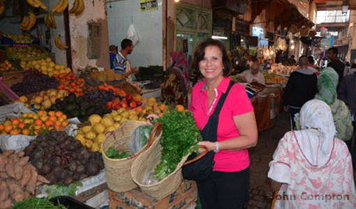 Kathy shopping with the chef for their cooking lesson in Morocco.