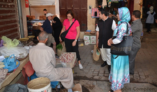 Kathy shopping with the chef for their cooking lesson in Morocco.